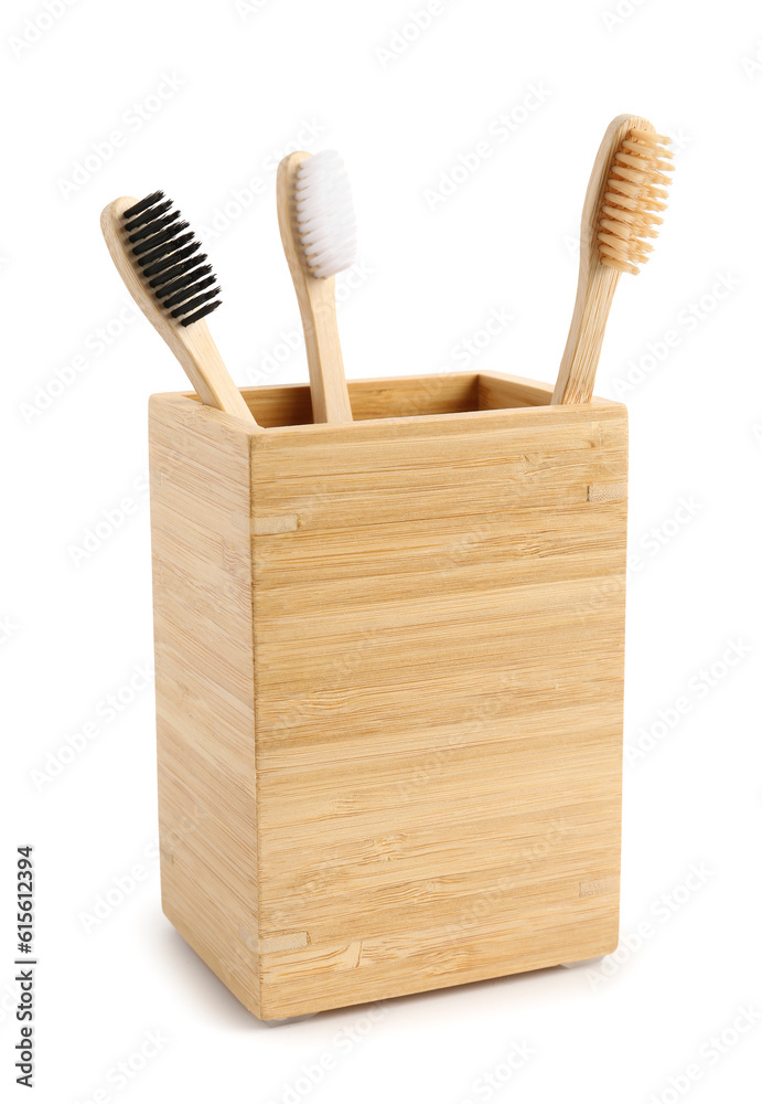 Bamboo tooth brushes in holder on white background