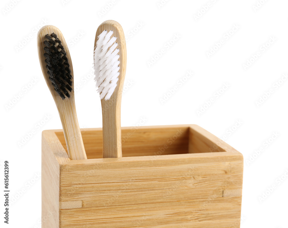 Bamboo tooth brushes in holder on white background, closeup