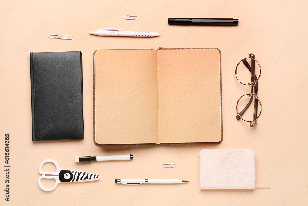 Notebooks with different stationery on pale orange background