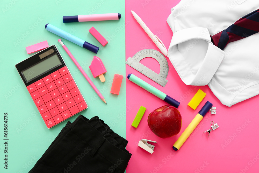 School uniform with fresh apple, calculator and different stationery on color background