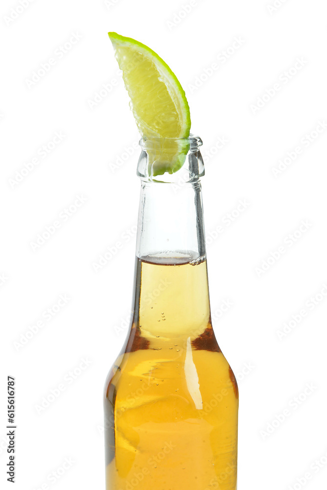 Bottle of cold beer with lime on white background