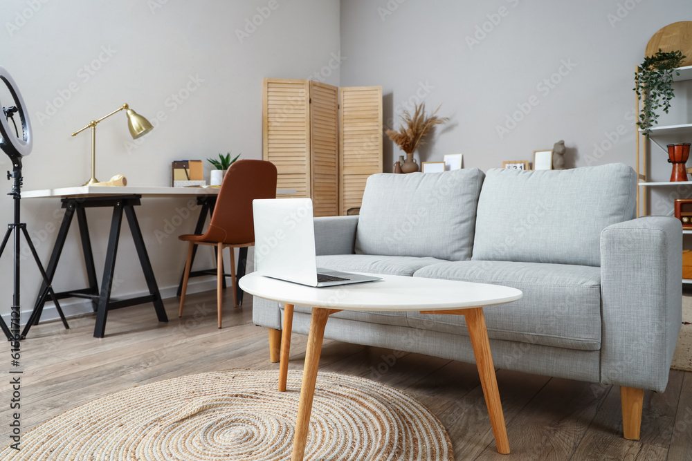 Interior of living room with sofa and workplace