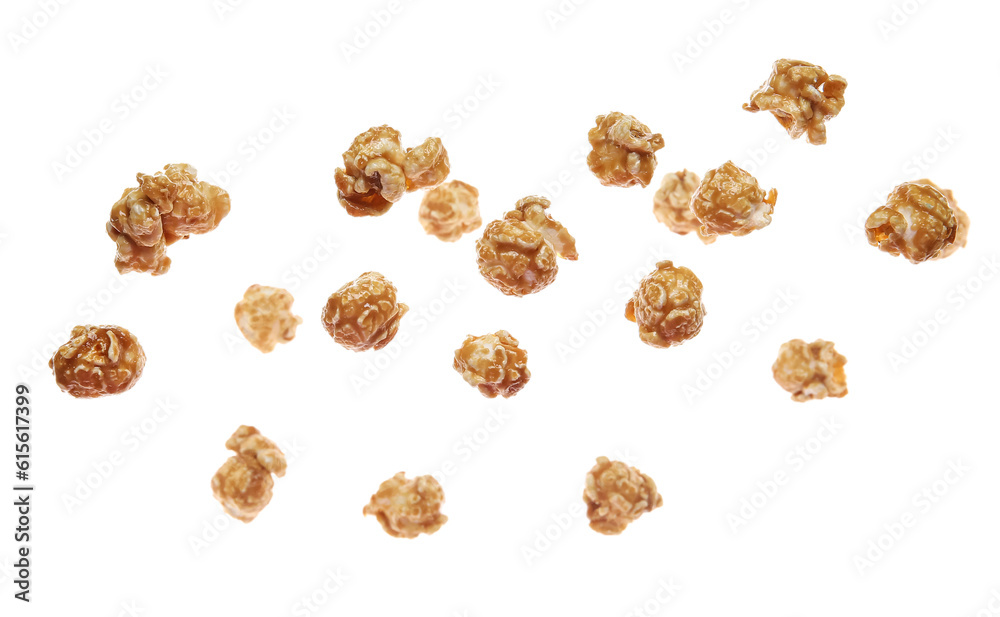 Flying tasty caramel popcorn on white background