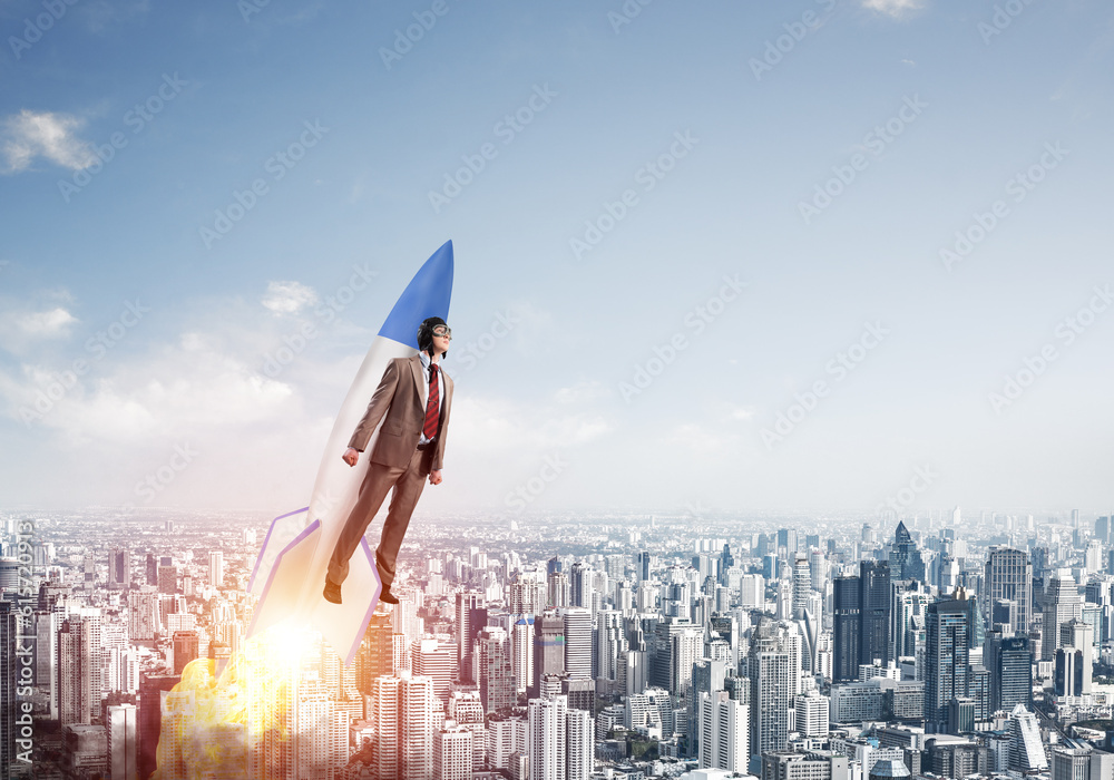 Business person in aviator hat flying on rocket