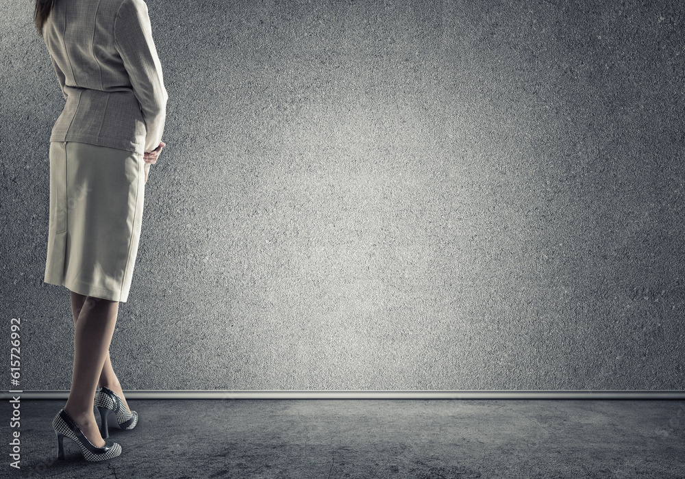 Businesswoman looking at wall