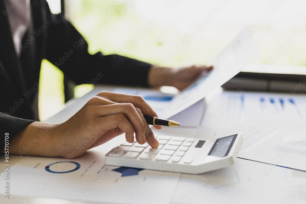 Businesswoman working analyzing business growth charts in documents, financial reports and investmen