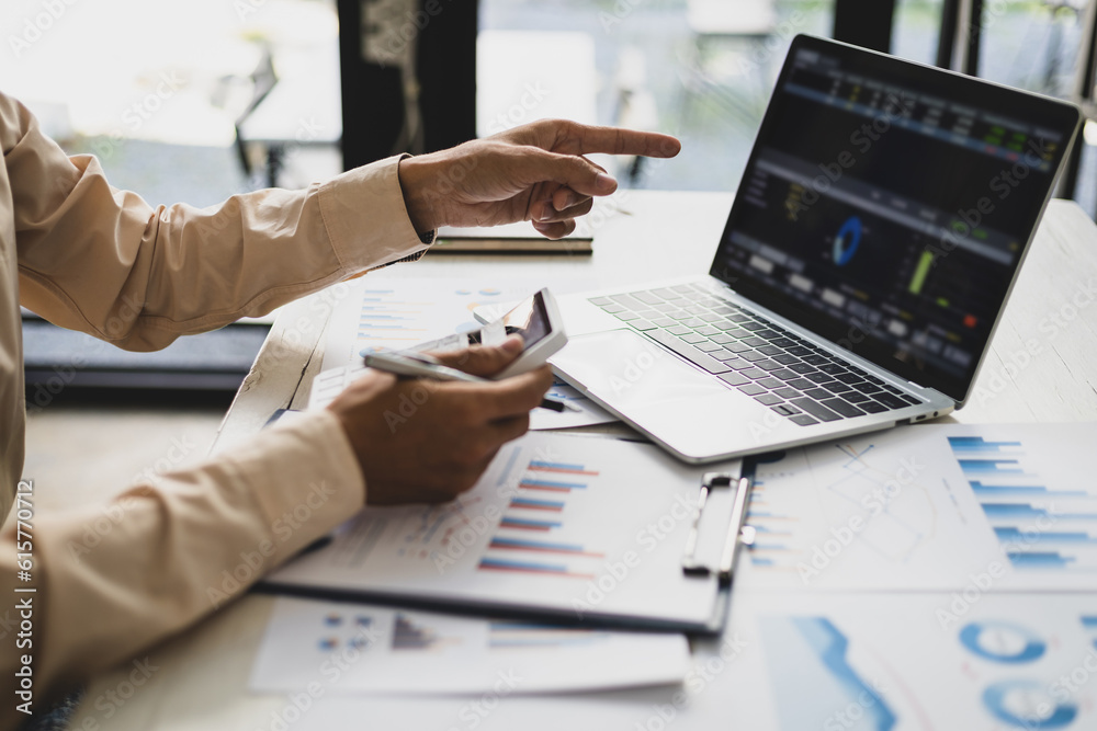 Businessman pointing at financial chart document and statistical market growth analysis. Accounting 