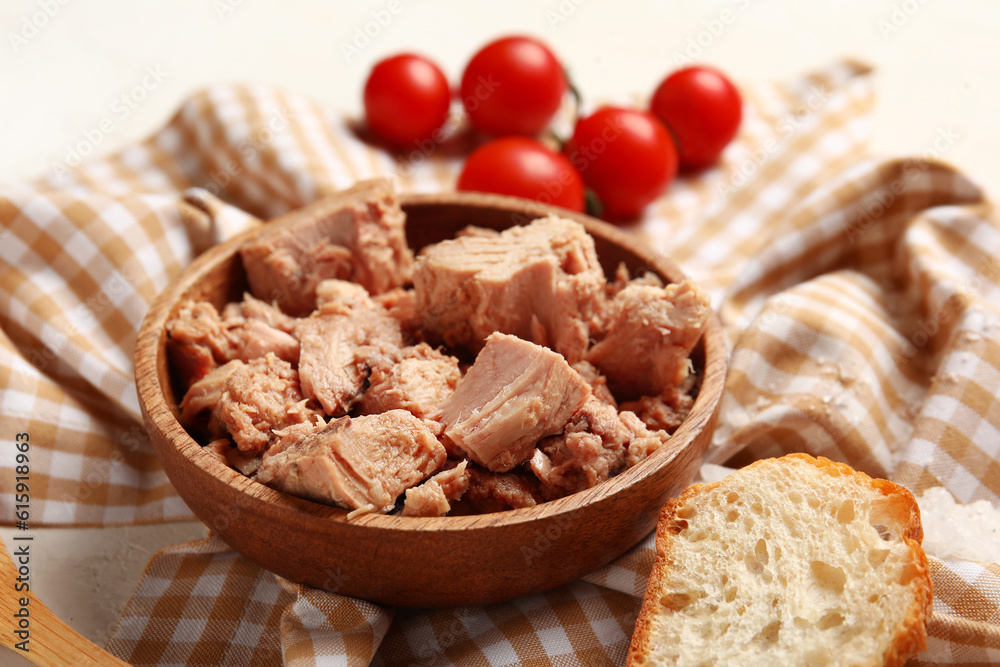 Bowl with delicious canned tuna on crumpled napkin, closeup