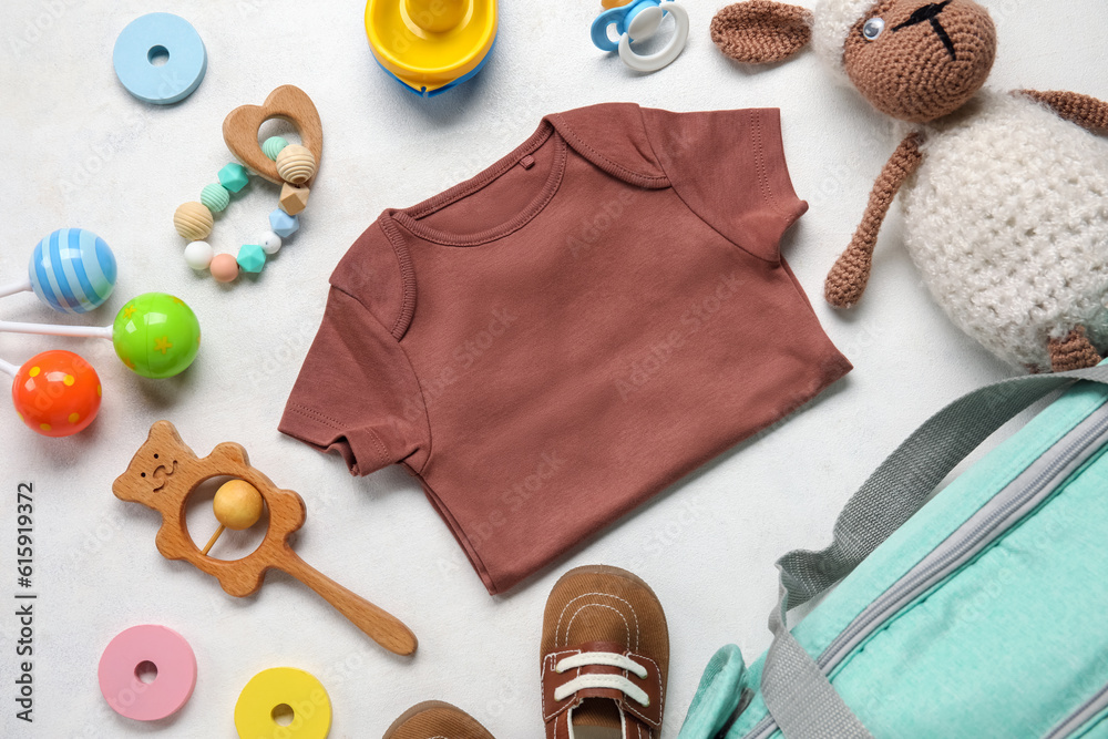 Composition with baby clothes and toys on white background