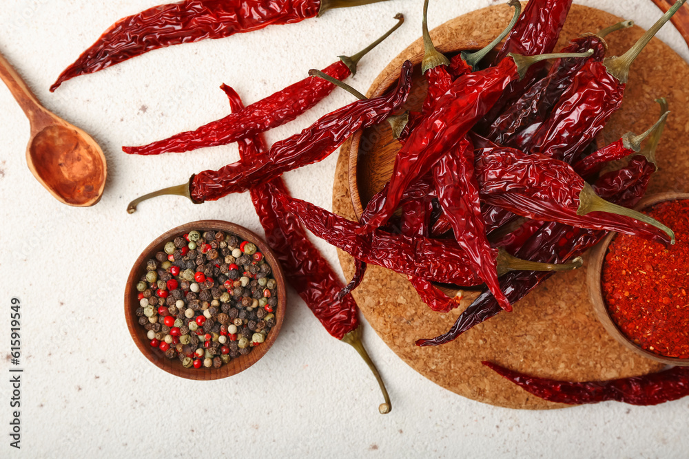 Composition with dry hot chili peppers and spices on white background