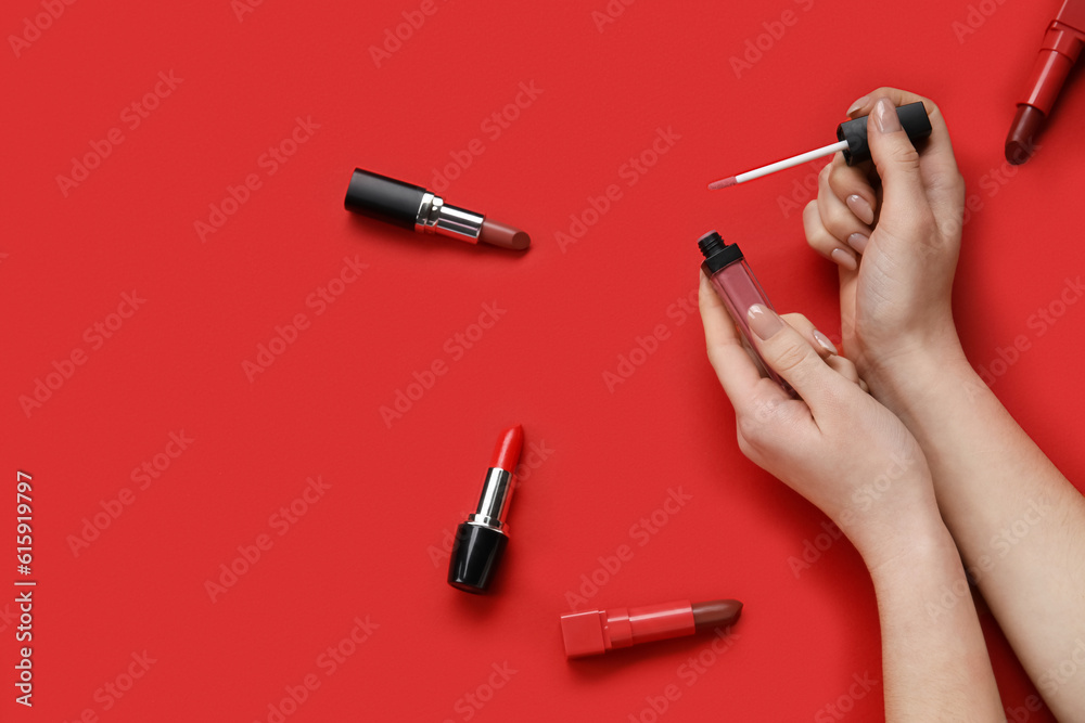 Woman with lipsticks on red background