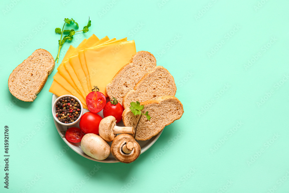 Board of tasty processed cheese with vegetables and bread on turquoise background