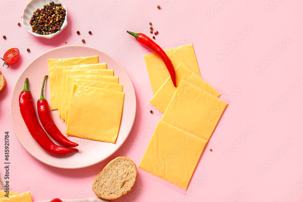 Plate of tasty processed cheese with bread and chilli on pink background