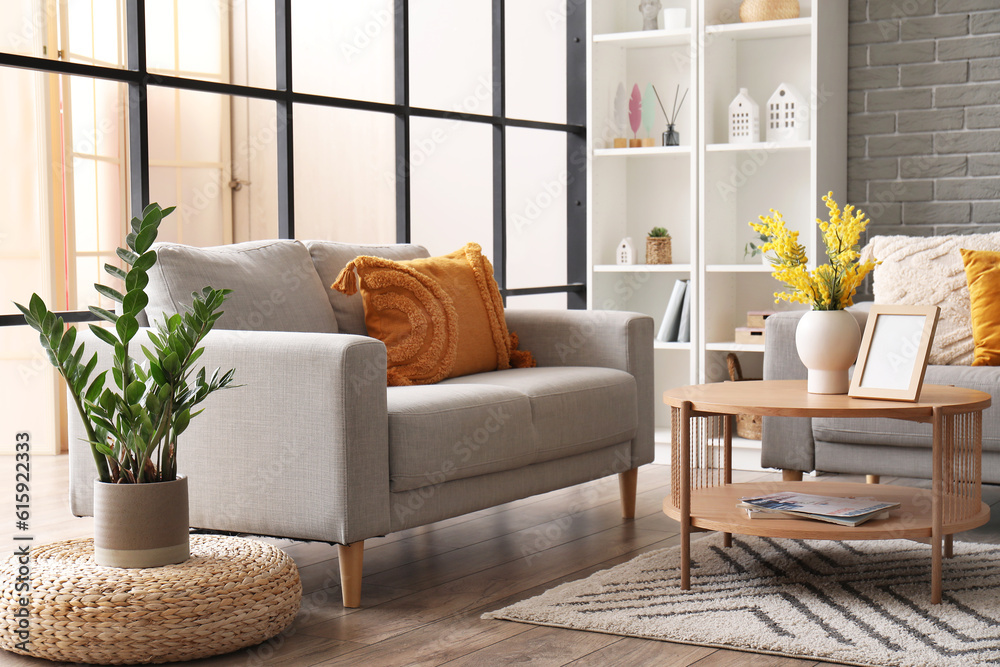 Interior of modern living room with sofas, coffee table and shelving unit