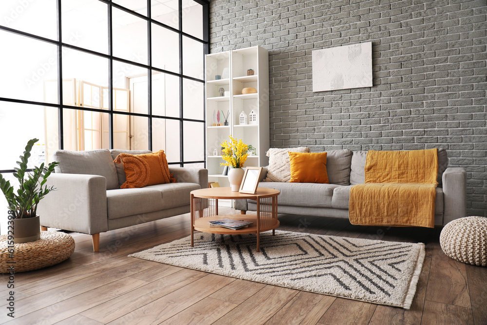 Interior of modern living room with sofas, coffee table and shelving unit