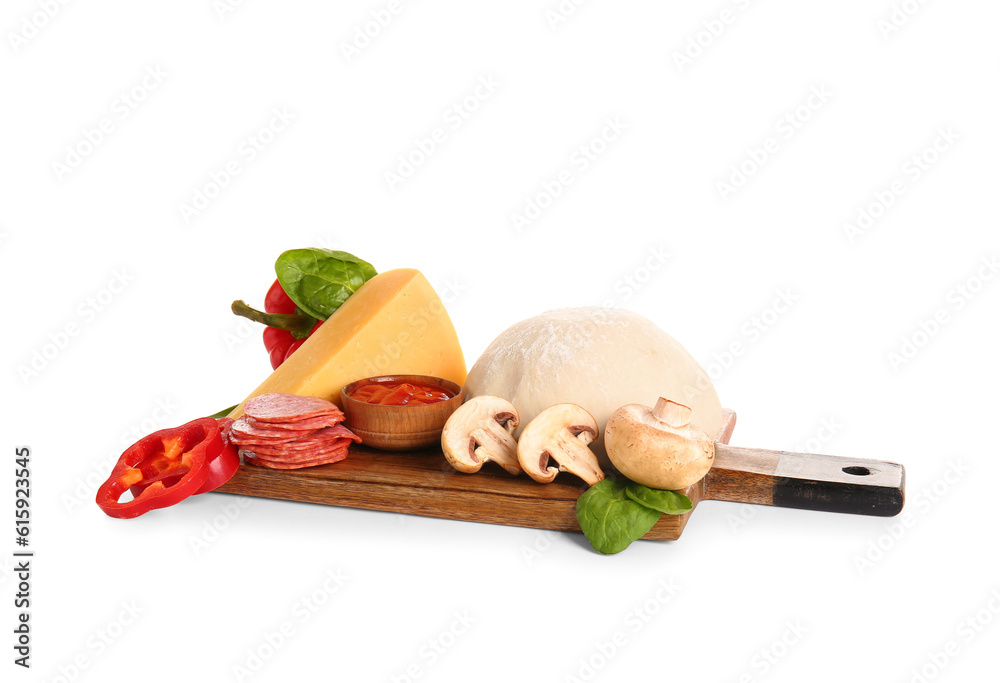 Wooden board with raw dough and ingredients for preparing pizza on white background