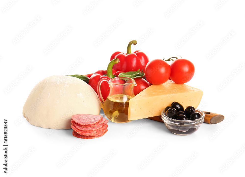 Raw dough and ingredients for preparing pizza on white background