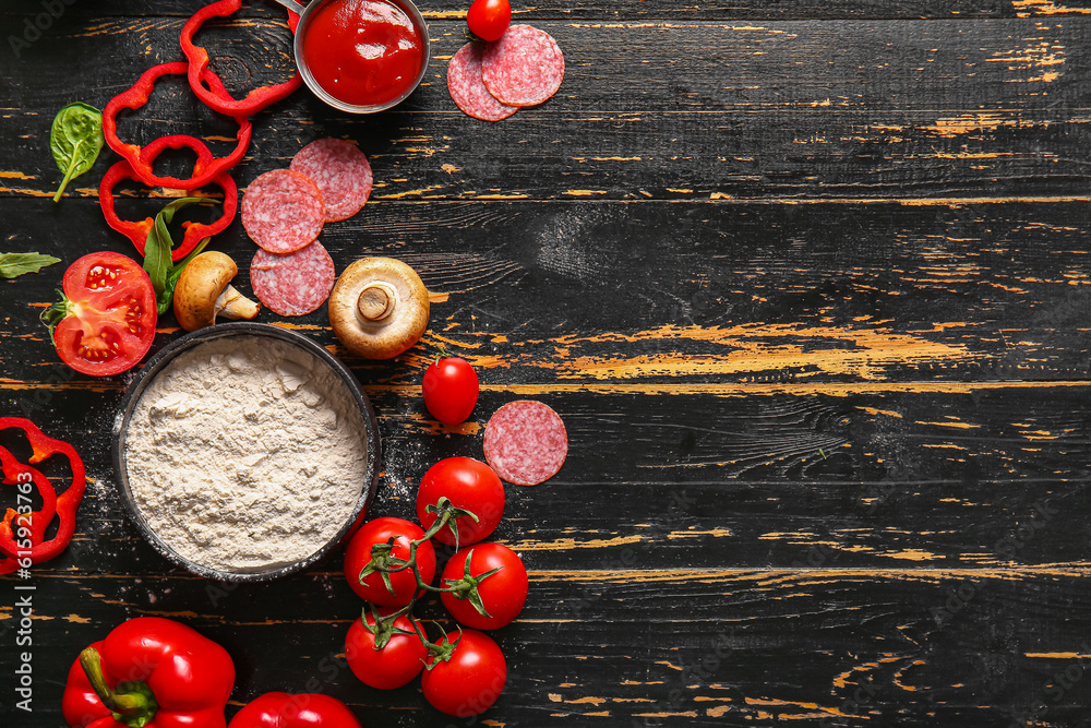 Different ingredients for preparing pizza on dark wooden background