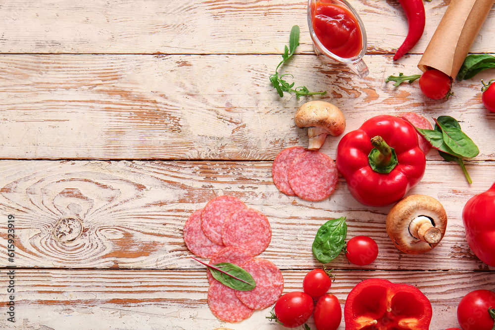 Different ingredients for preparing pizza on light wooden background