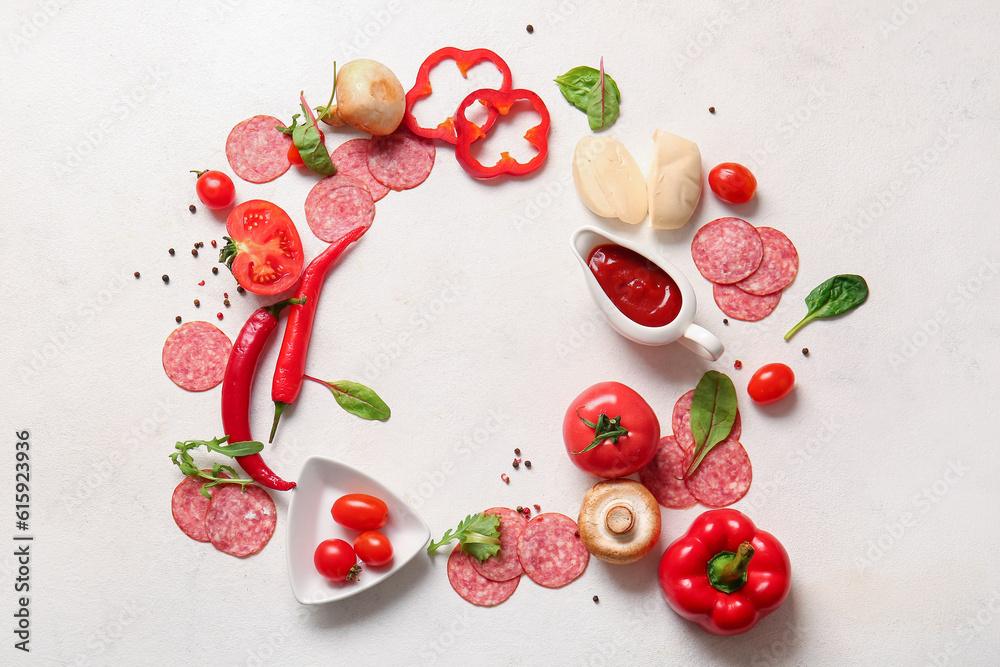 Frame made of different ingredients for preparing pizza on light background