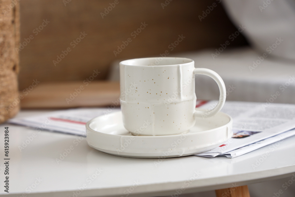 Saucer with cup of coffee on table, closeup