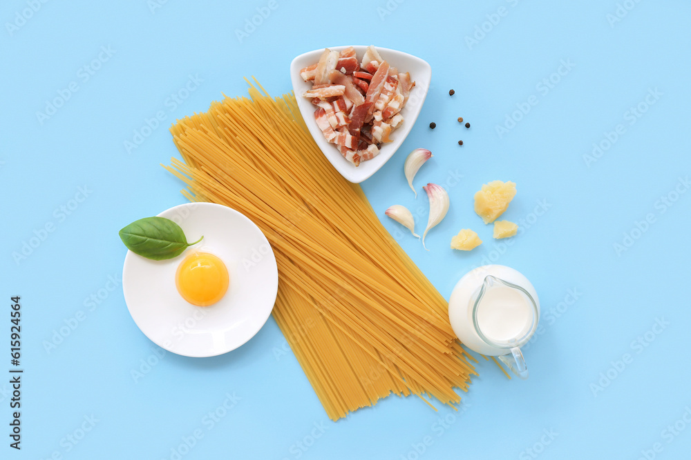 Ingredients for tasty pasta carbonara on blue background