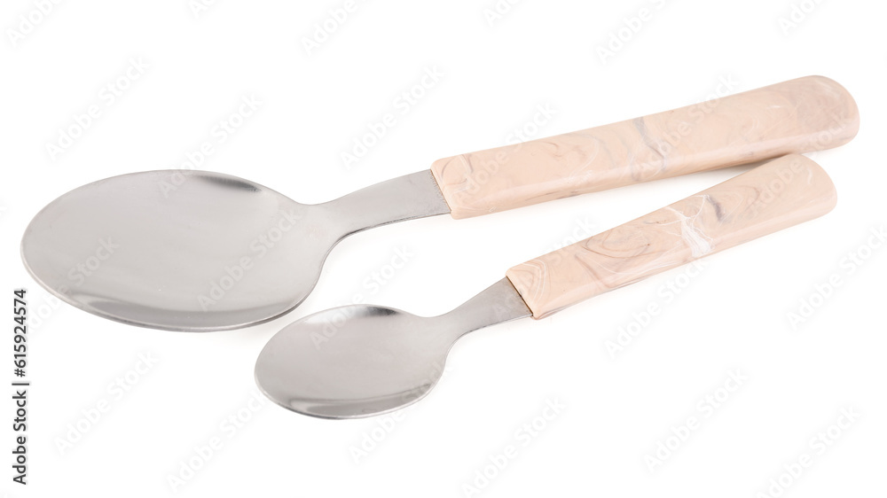 Stainless steel spoons with plastic handles on white background