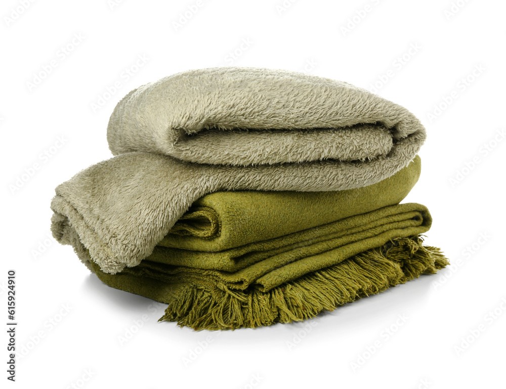 Different soft folded blankets on white background