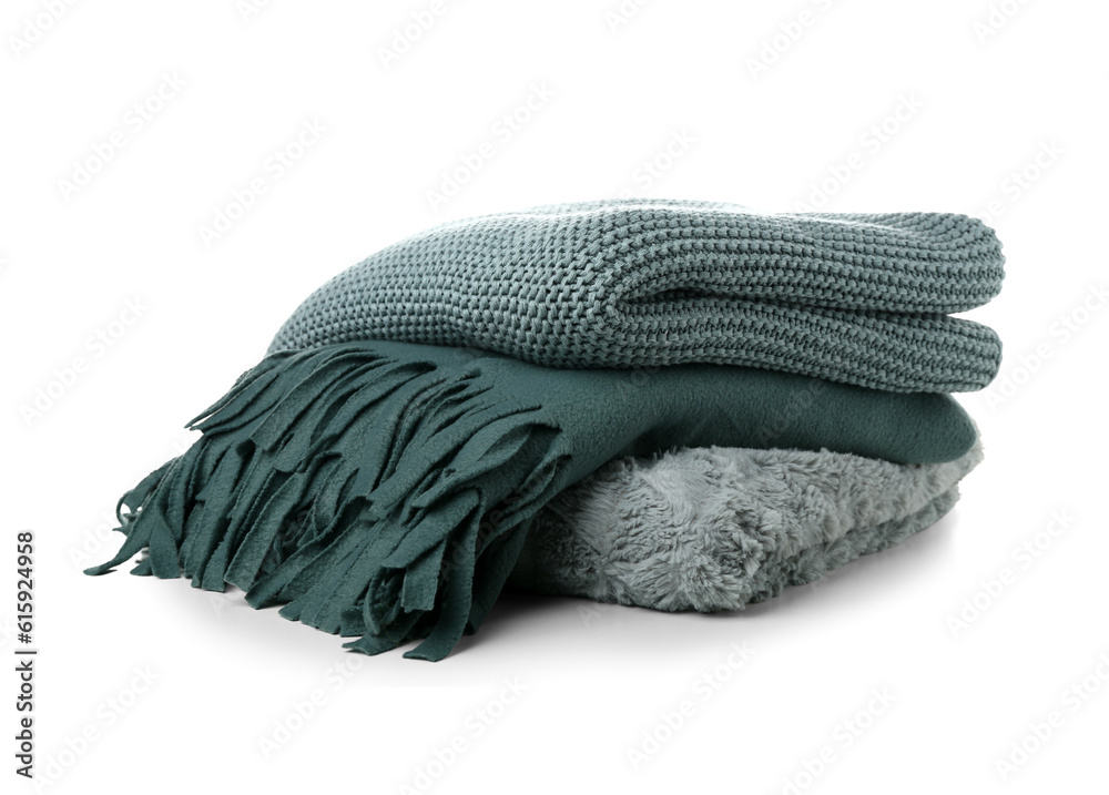 Different soft folded blankets on white background