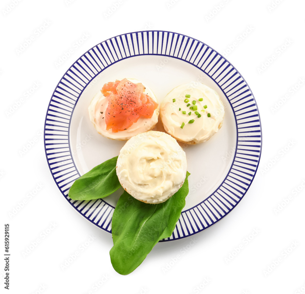 Plate of tasty croutons with cream cheese and fish on white background