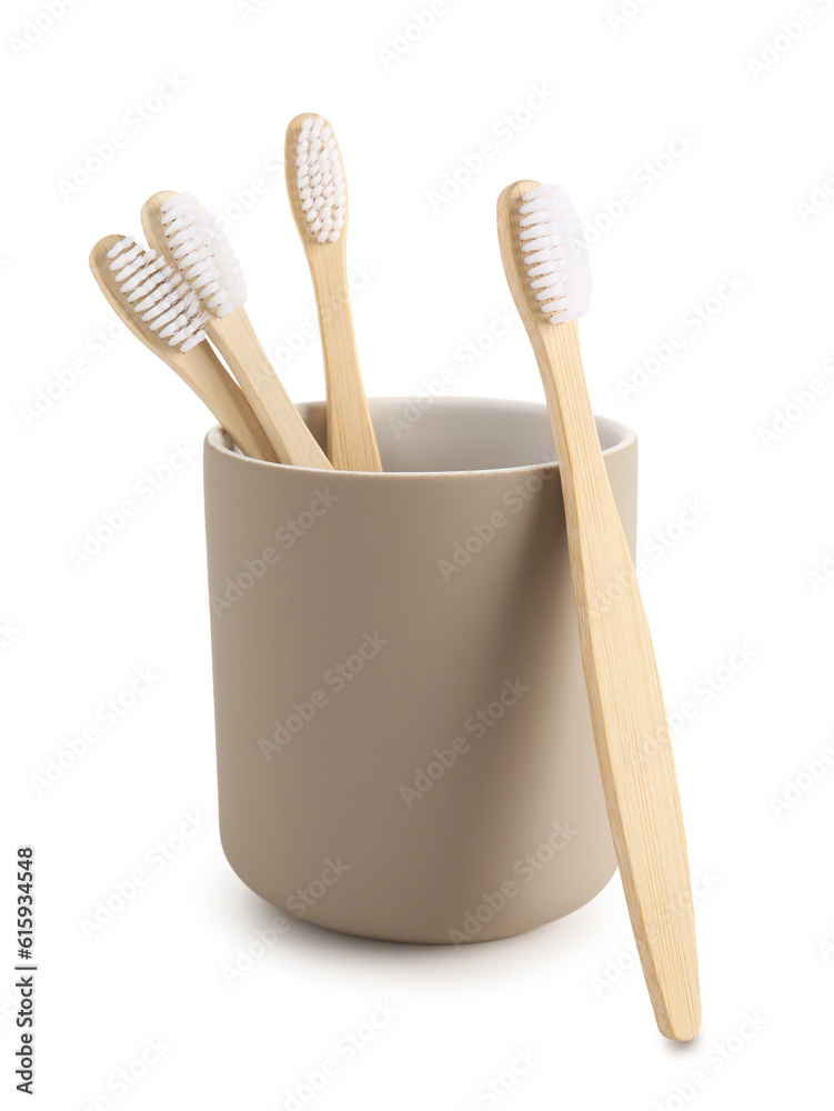 Bamboo tooth brushes in holder on white background