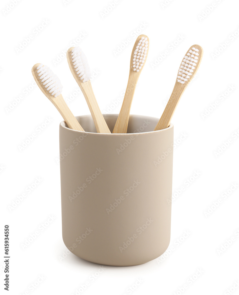 Bamboo tooth brushes in holder on white background