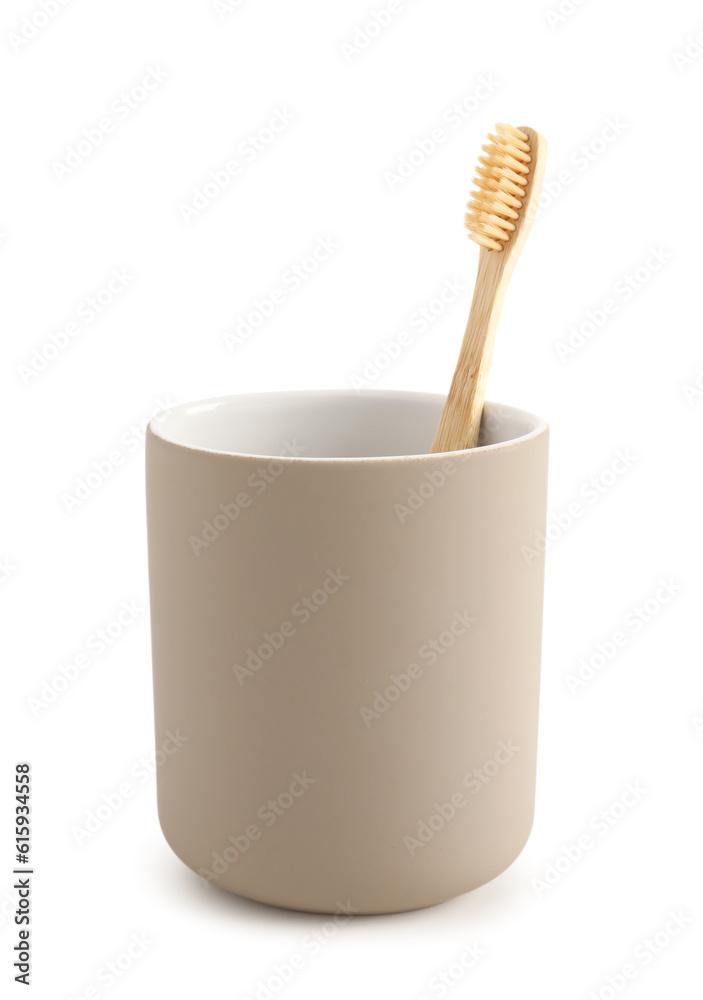 Bamboo tooth brush in holder on white background