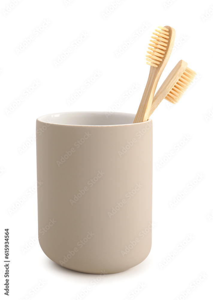 Bamboo tooth brushes in holder on white background