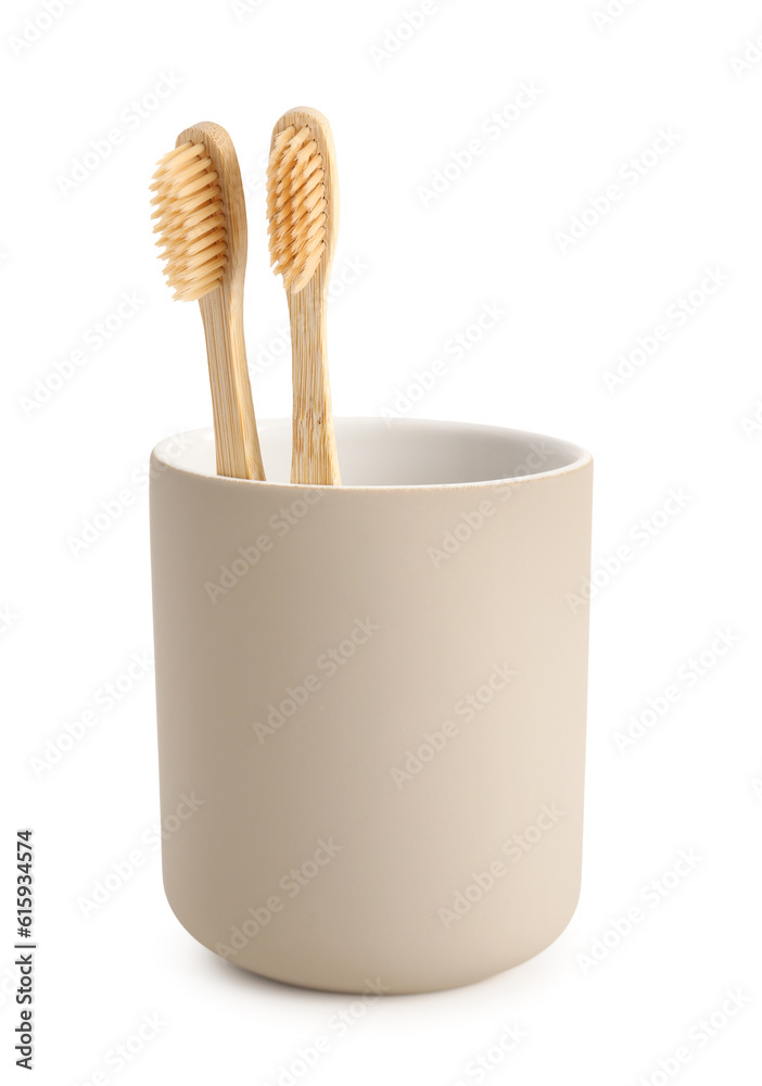 Bamboo tooth brushes in holder on white background