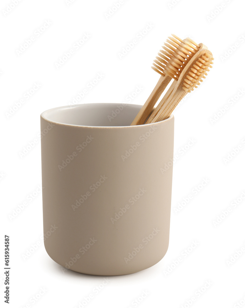 Bamboo tooth brushes in holder on white background