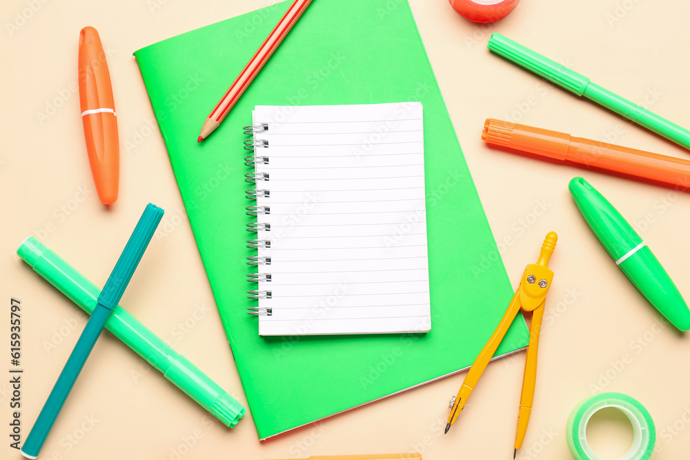 Notebooks with different stationery on pale orange background