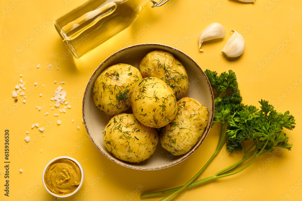 Plate of boiled baby potatoes with dill and mustard on yellow background