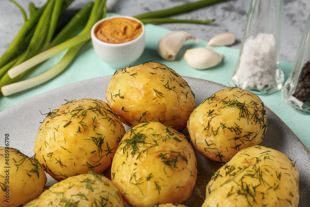 Plate of boiled baby potatoes with dill and mustard, closeup