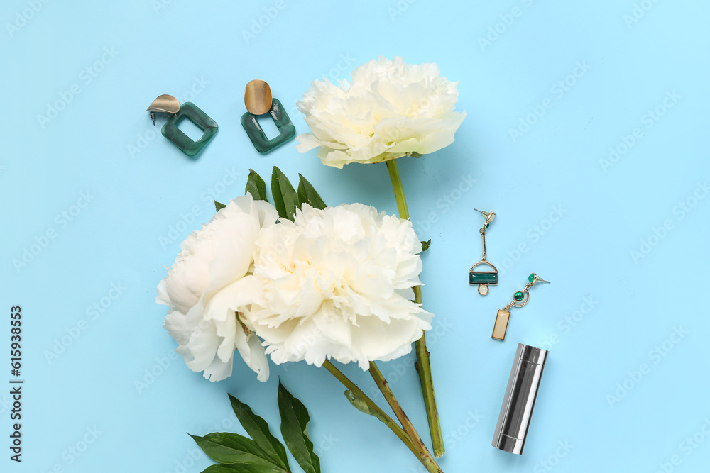 Composition with beautiful peony flowers, earrings and lipstick on color background