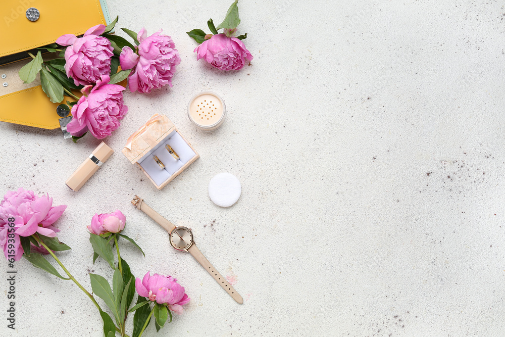 Composition with wedding rings, female accessories, cosmetics and beautiful peony flowers on light b