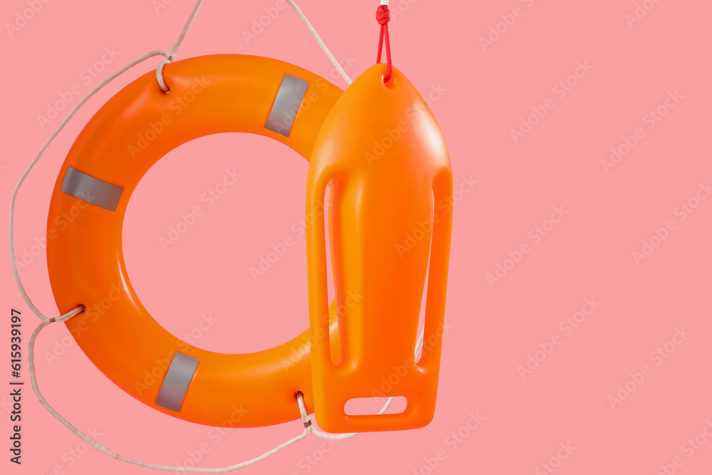 Ring buoy with board on pink background