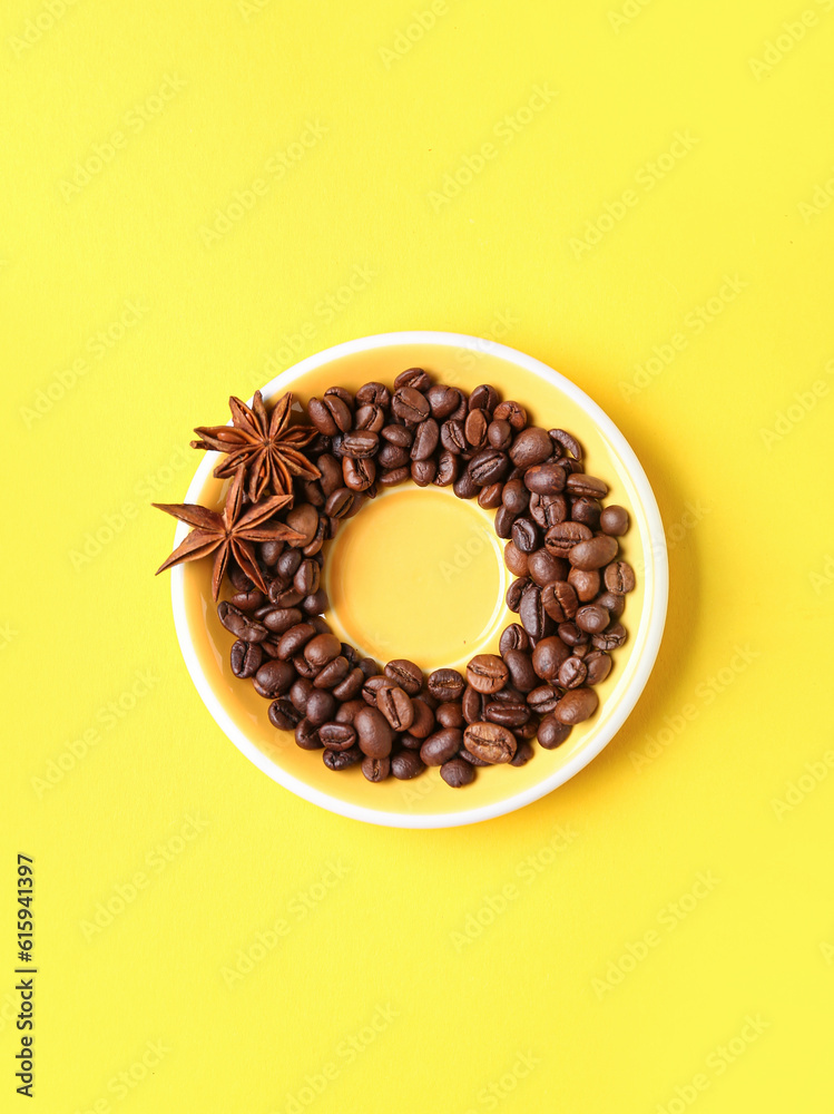 Frame made of coffee beans and star anise on yellow background