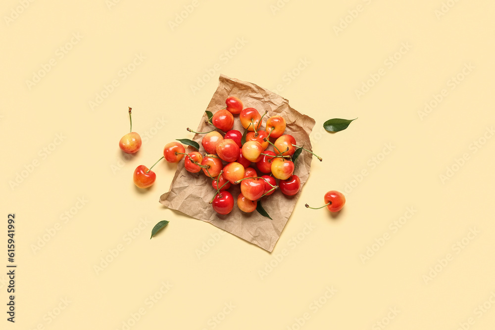 Paper with sweet cherries on light background