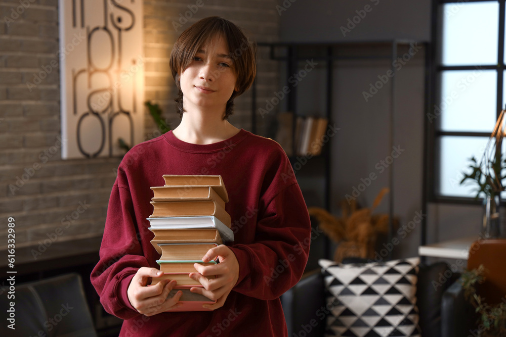 Teenage boy with books at home late in evening