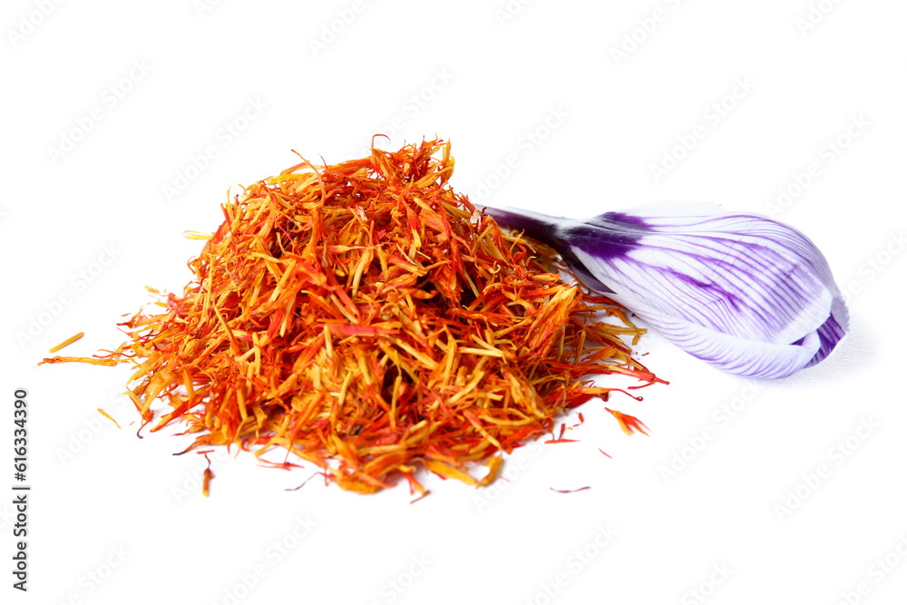 Heap of dried saffron threads and crocus flower isolated on white background