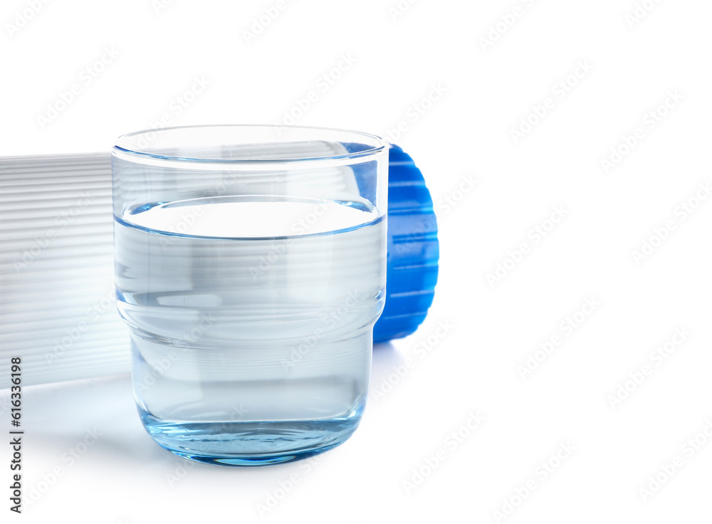 Glass of liquid and water filter cartridge isolated on white background