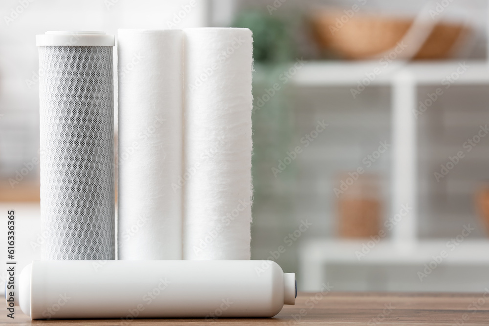 Water filters on wooden table in kitchen