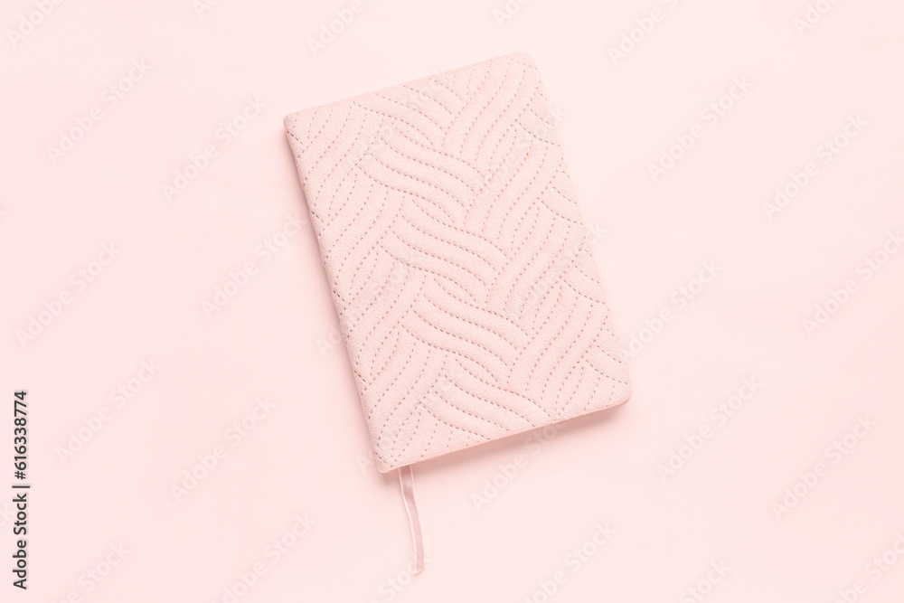 Stylish notebook on pink background