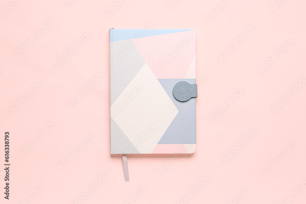 Modern notebook on pink background